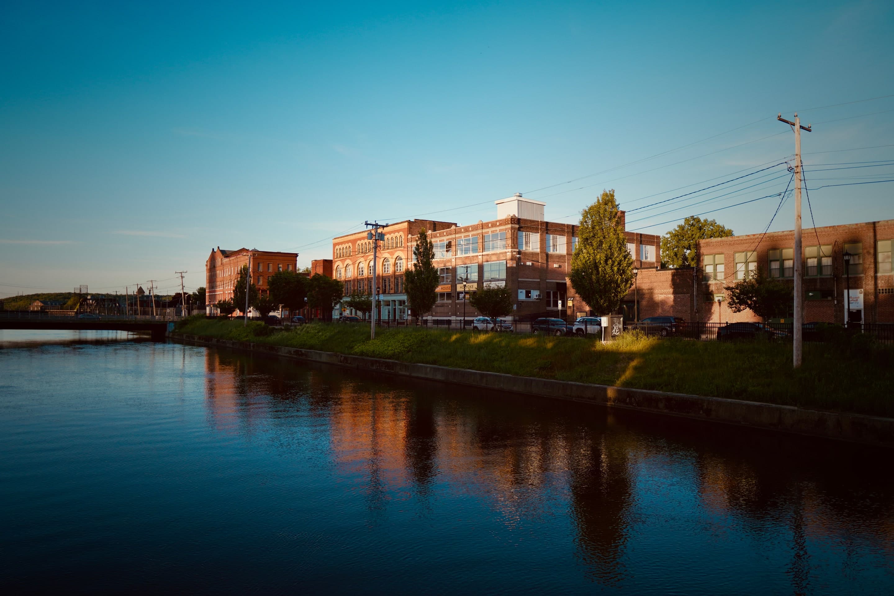 Golden evening light on the canal beside the Creator Campus buildings in Holyoke's Canal District