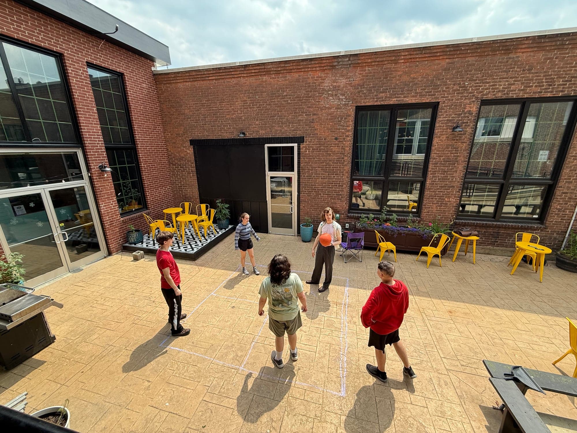 Students playing four square in the courtyard